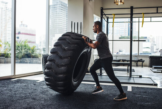 Sportsman Doing Exercise with Truck Tire