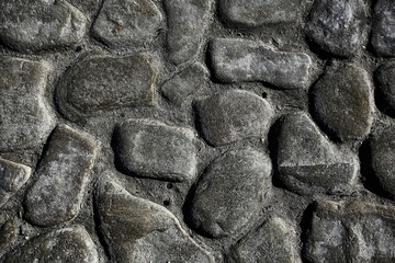 old stone pavement background / abstract pavement, large cobblestones, old road texture