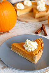 Traditional thanksgiving food on wooden table. Orange delicious homemade pumpkin pie with crust and...