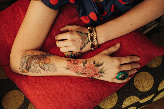 Close Up Of Woman's Hands Covered In Colorful Tattoos