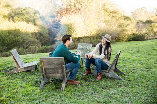 Couple sitting at outdoor fire pit
