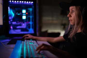 Gamer girl playing on the computer, at home.