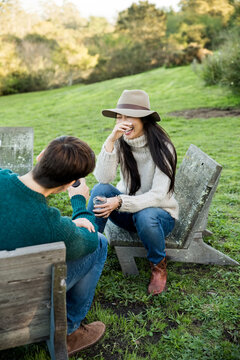 Couple sitting at outdoors drinking wine