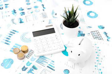 Accounting concept. Piggy bank, calculator, graph, coins on white background. Top view.