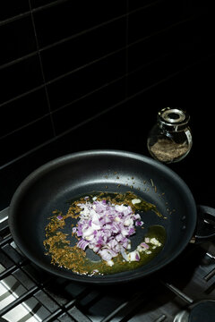 Ingredients cooking on stove top for Baingan Bharta (Indian Eggp