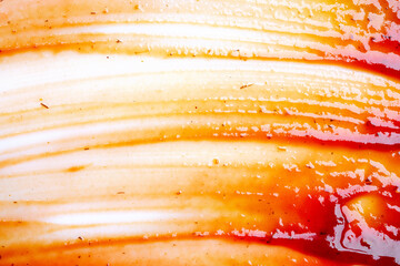 Smeared barbecue sauce or ketchup isolated on white background, close up. Flat lay, top view. Free copy space for text.