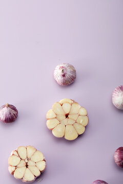 Garlic with design placed on pink purple background