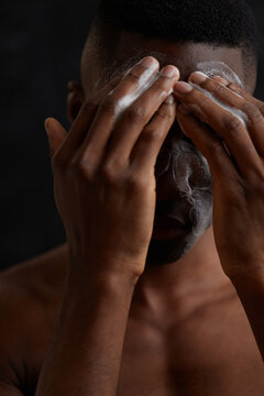 Unrecognisable African American man washing face