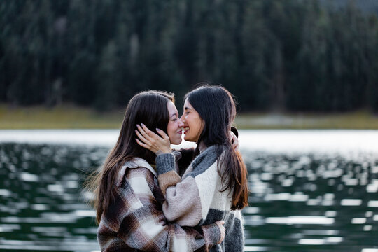 Two friends showing affection on a weekend outing.