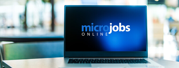 Laptop computer displaying the sign "micro jobs online"
