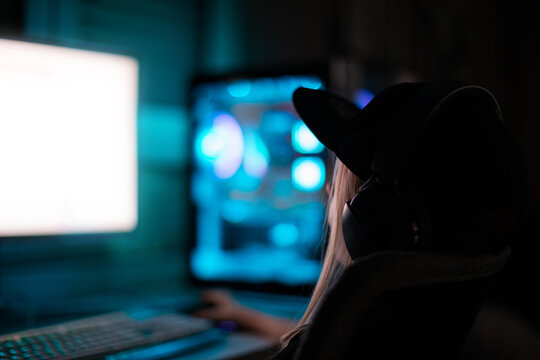Gamer girl playing on the computer, at home.