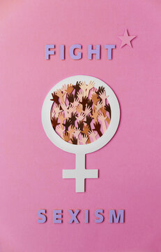 Fight sexism text and femal symbol full of women hands in multi colored skin