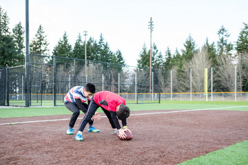 Asian Kids Playing American Football in an Outdoor Field