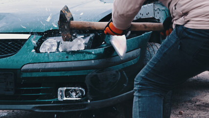 Close up, man hand breaking car lights with big hammer. High quality photo