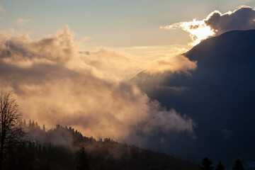 Fototapeta premium Krasnaya Polyana, Sochi, the mountains of the North Caucasus, snow-capped peaks against the background of autumn trees,