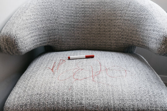 Red scribbles on a chair