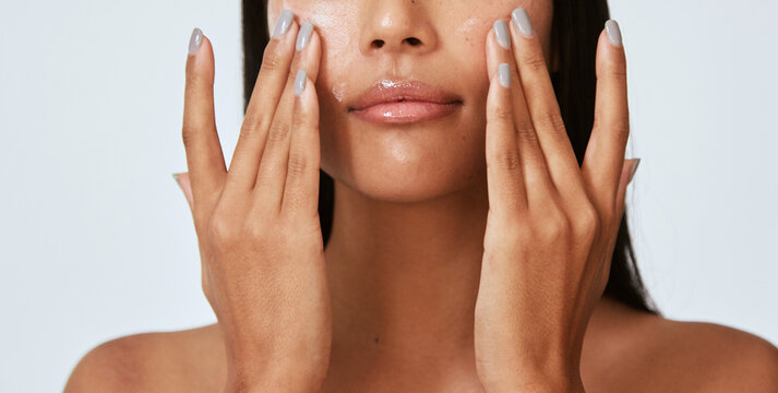 Woman Applying Face Lotion - Natural Skincare