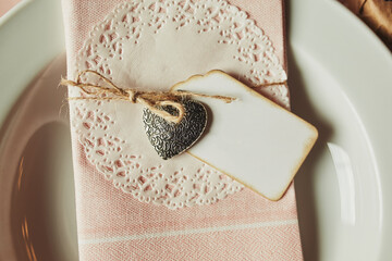 Festive table setting for Valentine's Day withtable napkin, sign for the inscription and hearts
