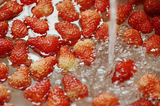 The process of home-made pink strawberry cake, strawberry washing