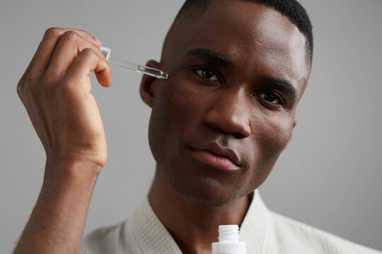 Man using a serum dropper