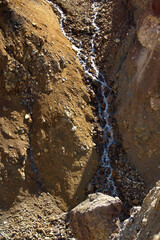 Mutnovsky volcano. Got creek runs along the slope on the crater of the active volcano