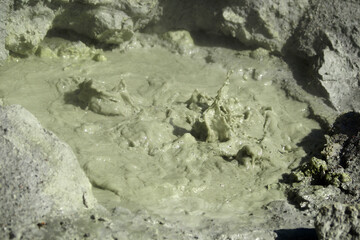 Mutnovsky volcano. Small geysers of hot sulfur mud (mud volcanoes) in the crater of the active volcano