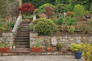 Natural stone steps and retaining wall, planter and garden border framing home entrance. Beautiful...