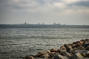 
distant photo of a shipyard at sea