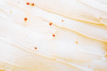 Smeared barbecue sauce or ketchup isolated on white background, close up. Flat lay, top view. Free copy space for text.