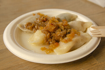 
bright dumplings with cheese and roux