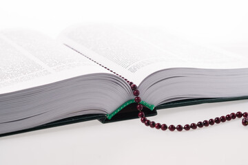 Bible book open on white background