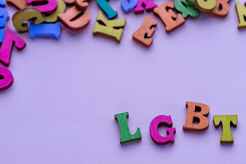 Multi-colored letters of lgbt on the lilac background