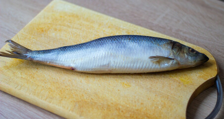 salted herring lies on  cutting board