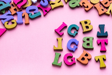 Multi-colored letters of lgbt on pink background