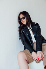 Portrait of a beautiful fashionable brunette woman in a black jacket