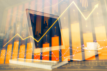 Financial chart drawing and table with computer on background. Double exposure. Concept of...