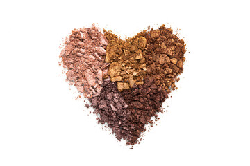 Heart composition eye shadow crushed samples isolated on white background top view