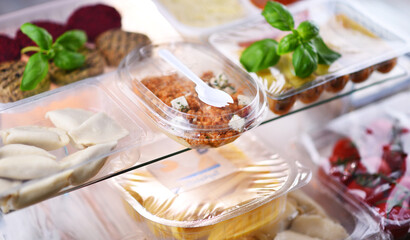 A variety of prepackaged food products in plastic boxes
