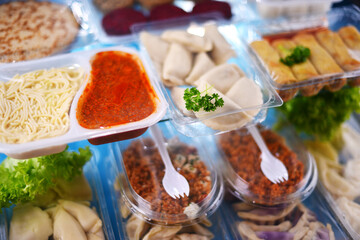 A variety of prepackaged food products in plastic boxes