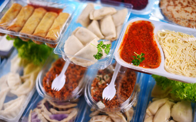 A variety of prepackaged food products in plastic boxes