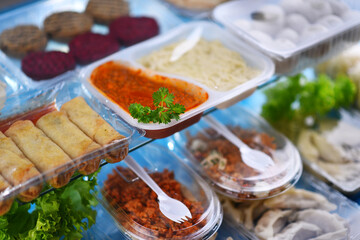 A variety of prepackaged food products in plastic boxes