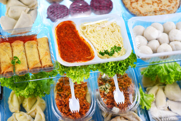 A variety of prepackaged food products in plastic boxes