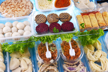 A variety of prepackaged food products in plastic boxes