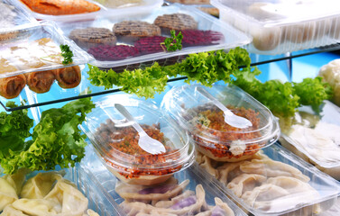 A variety of prepackaged food products in plastic boxes