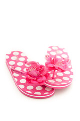 Pink and white polka dot flip flops isolated on a white studio background