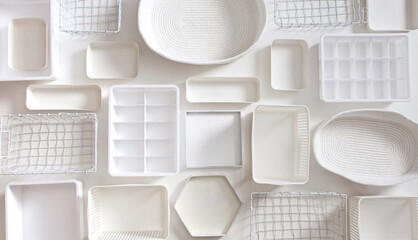 Flat lay of Marie Kondo's white storage boxes, containers and baskets with different sizes and...