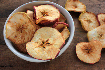 Dried fruits apples rings in a bowl, on wooden background. Top view. Rustic style