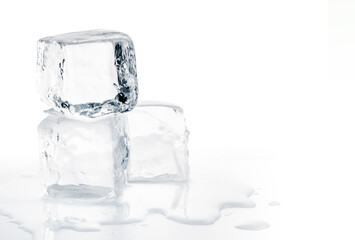 Natural crystal clear melting ice cubes on white background.