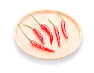 Red chili in a wooden plate on white background