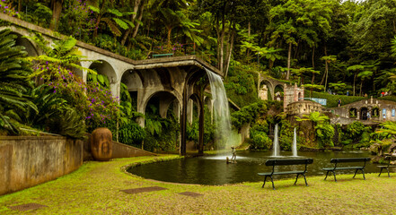 Obraz premium A view across the lake and fountains in the tropical garden above the city of Funchal Madeira